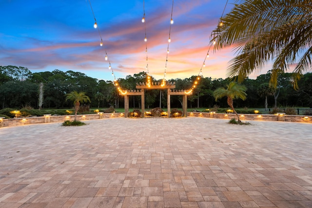 patio terrace at dusk featuring a pergola