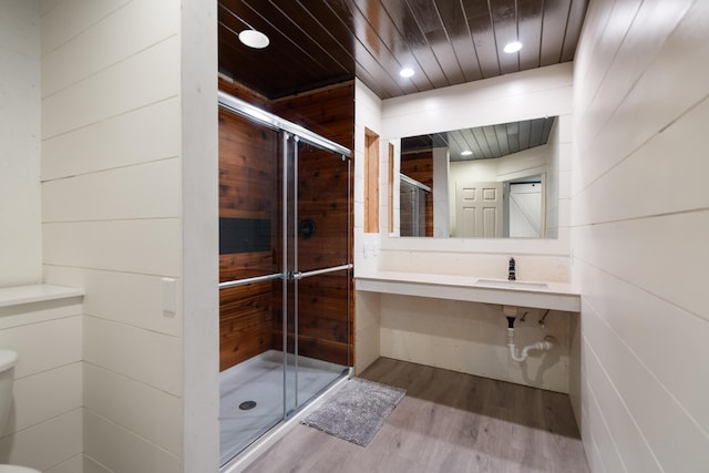 full bath with recessed lighting, toilet, wood ceiling, a shower stall, and wood finished floors