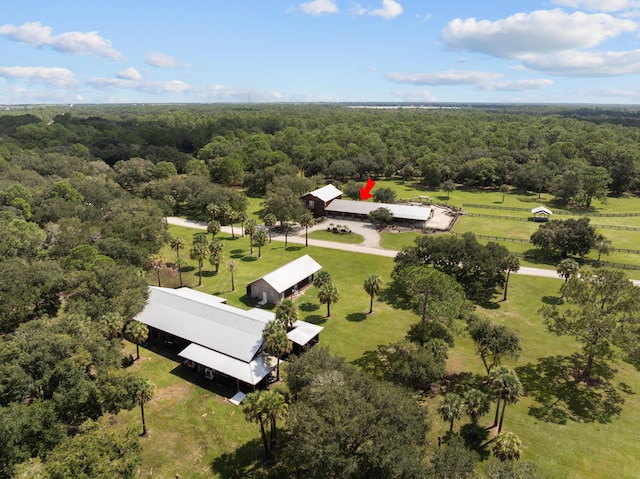 birds eye view of property with a forest view