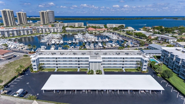 birds eye view of property featuring a water view and a city view