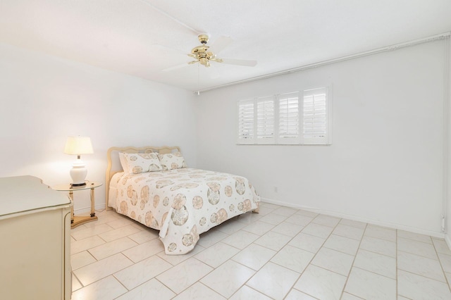 bedroom featuring a ceiling fan, baseboards, and light tile patterned floors