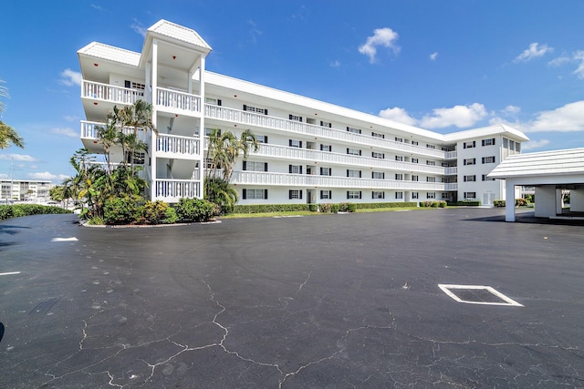 view of building exterior featuring uncovered parking