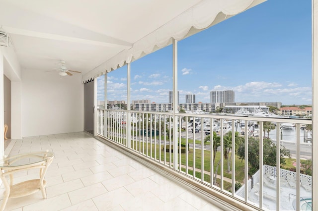 balcony with a view of city and ceiling fan