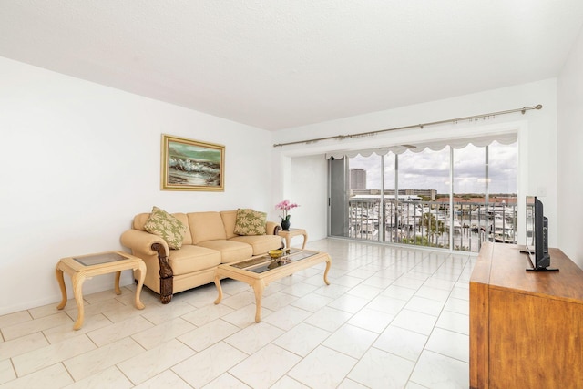 living room featuring light tile patterned floors and a textured ceiling