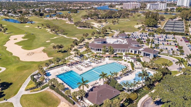 bird's eye view featuring golf course view and a water view