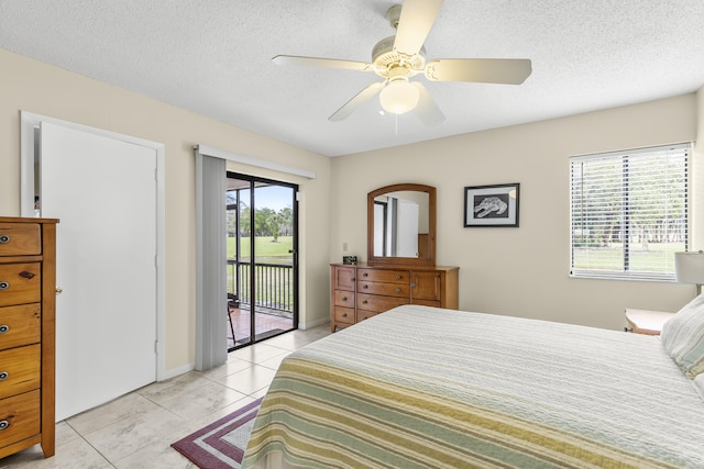 bedroom with access to exterior, a ceiling fan, a textured ceiling, and light tile patterned floors