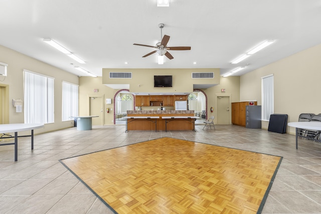 interior space with visible vents, a ceiling fan, and light tile patterned flooring