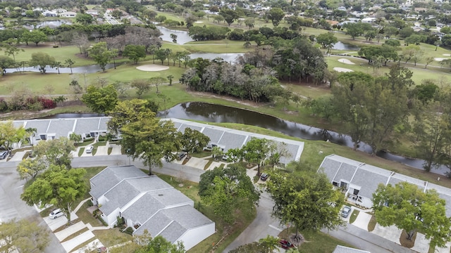 bird's eye view with golf course view, a water view, and a residential view