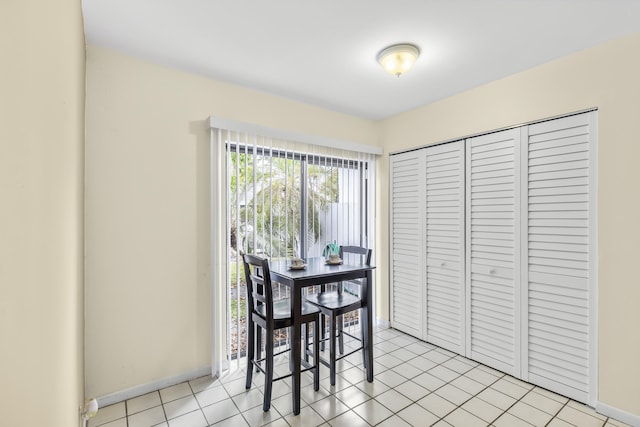 dining area with baseboards and light tile patterned floors