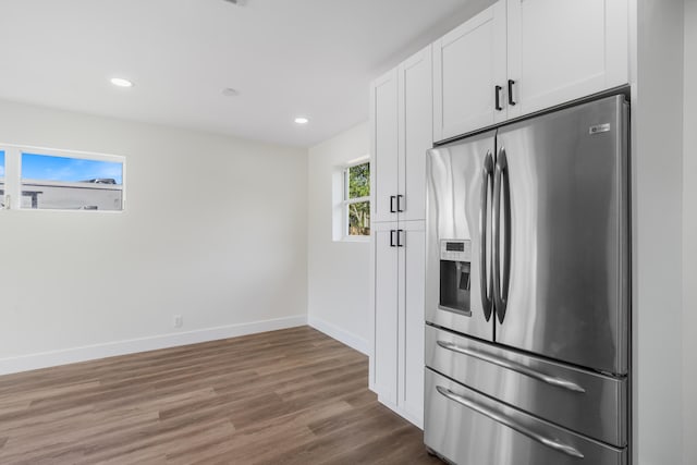 kitchen with baseboards, white cabinets, dark wood-style floors, stainless steel refrigerator with ice dispenser, and recessed lighting