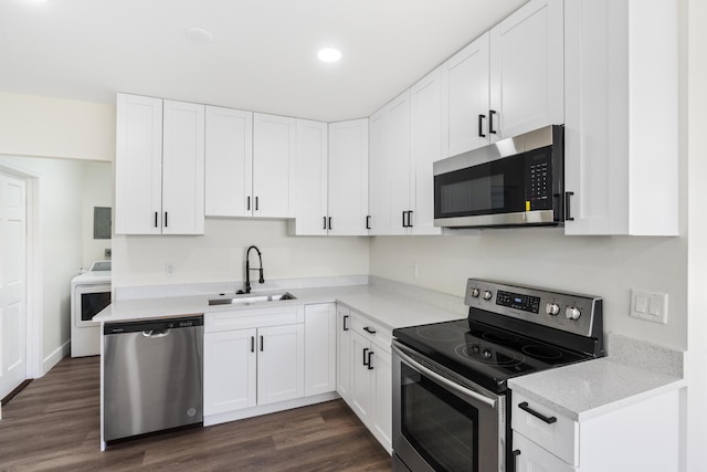 kitchen featuring white cabinets, dark wood-style floors, washer / clothes dryer, stainless steel appliances, and a sink