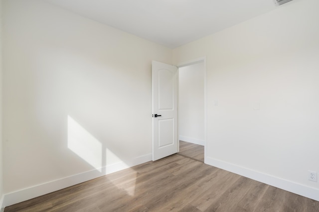 empty room with wood finished floors and baseboards