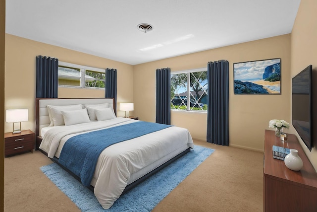 bedroom featuring light carpet, baseboards, and visible vents