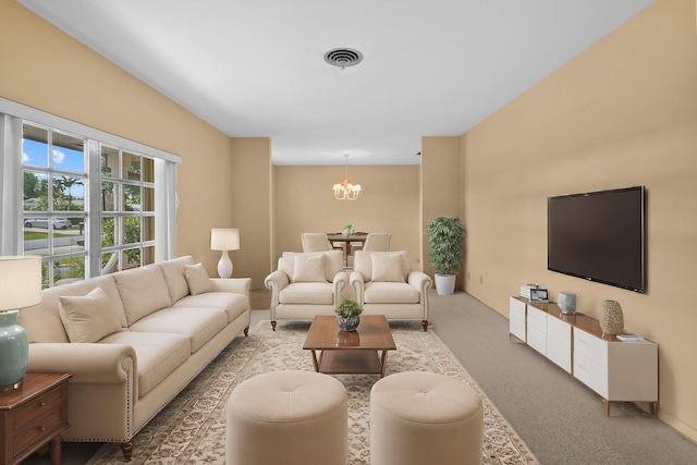 living room with carpet floors, an inviting chandelier, and visible vents