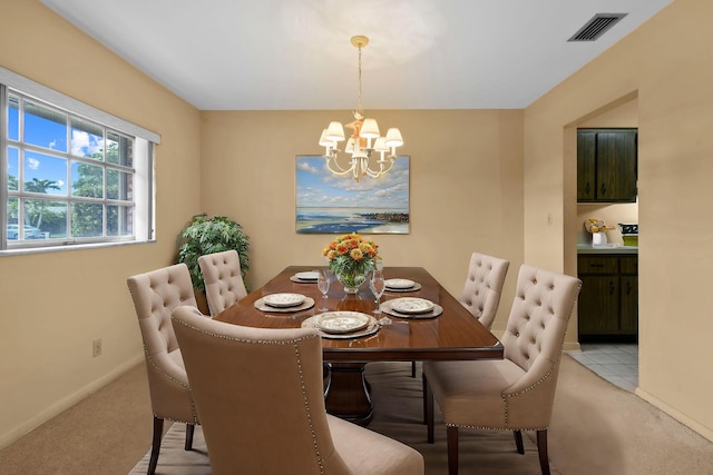 dining area with light carpet, baseboards, visible vents, and an inviting chandelier