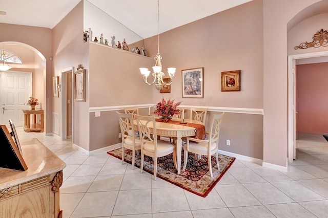 dining space with visible vents, arched walkways, a chandelier, and light tile patterned flooring