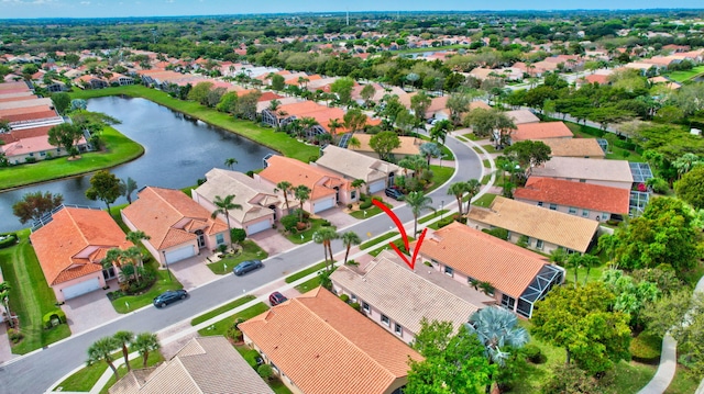 drone / aerial view with a water view and a residential view