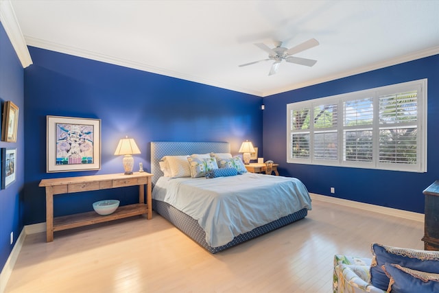 bedroom with ornamental molding, a ceiling fan, baseboards, and wood finished floors