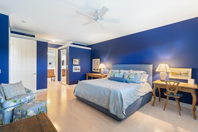 bedroom with a ceiling fan, crown molding, baseboards, and wood finished floors