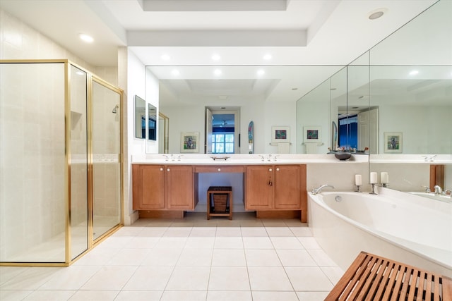 full bath with a tray ceiling, a shower stall, a bath, and tile patterned floors