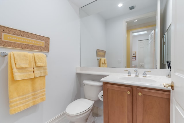 bathroom featuring toilet, recessed lighting, visible vents, and vanity