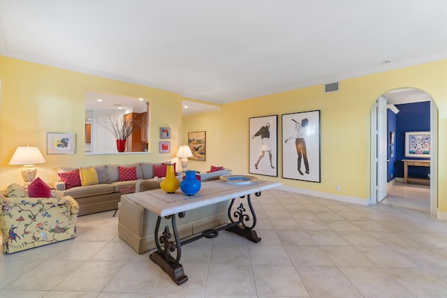 living area with arched walkways, light tile patterned flooring, visible vents, baseboards, and ornamental molding