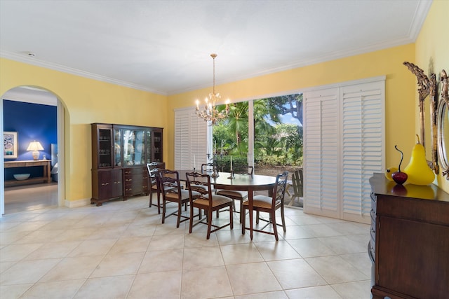 dining area with light tile patterned floors, arched walkways, an inviting chandelier, and ornamental molding