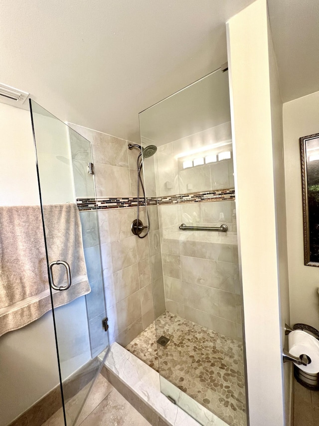 full bath featuring a shower stall and visible vents