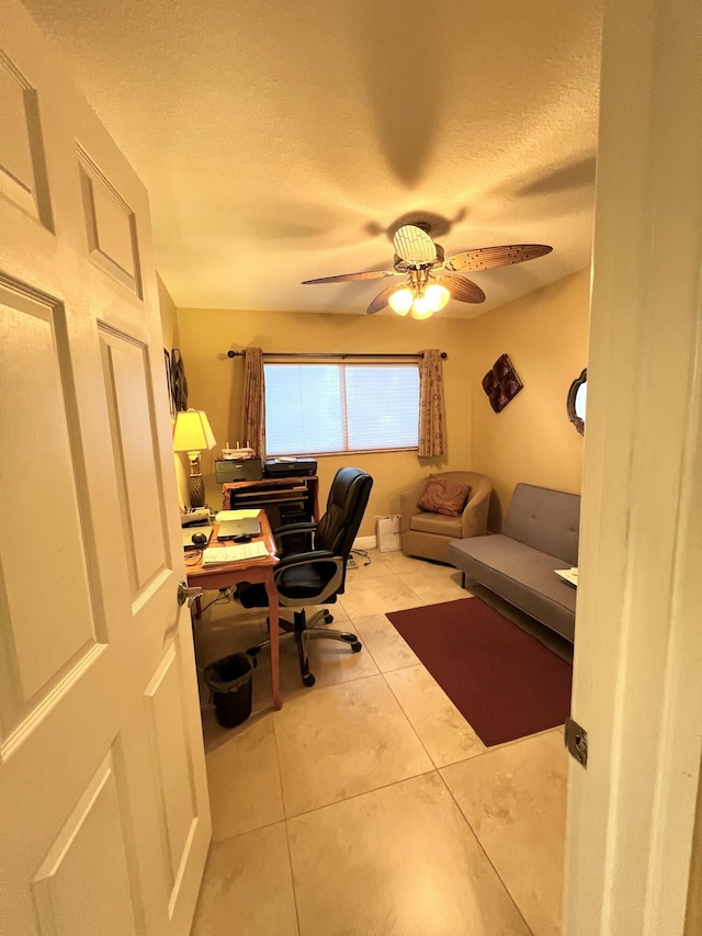 tiled office with a ceiling fan and a textured ceiling