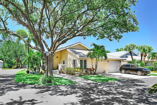 ranch-style house with an attached garage and concrete driveway