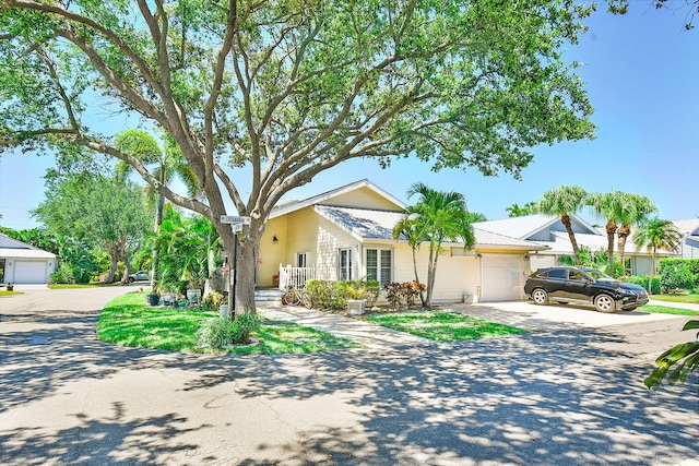 ranch-style home featuring a garage and driveway