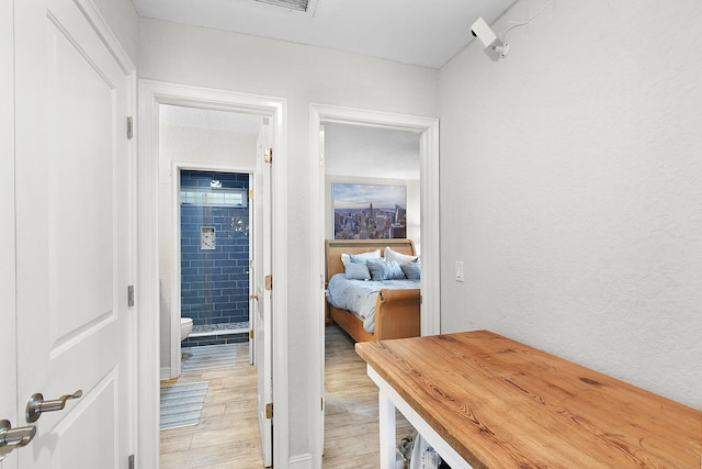 interior space featuring a textured wall and light wood-style flooring