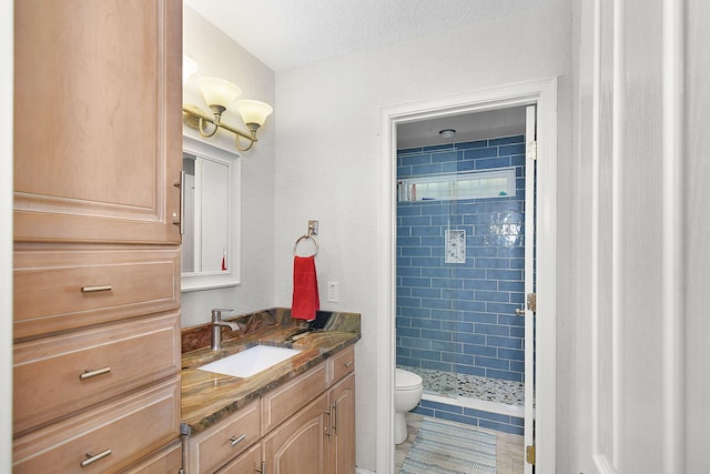 bathroom with a stall shower, tile patterned flooring, vanity, and toilet