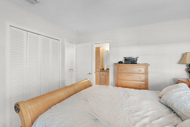 bedroom with a closet and ensuite bathroom