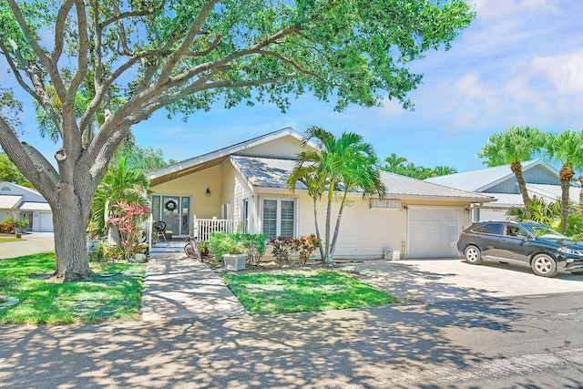 ranch-style home featuring a garage, driveway, and a porch