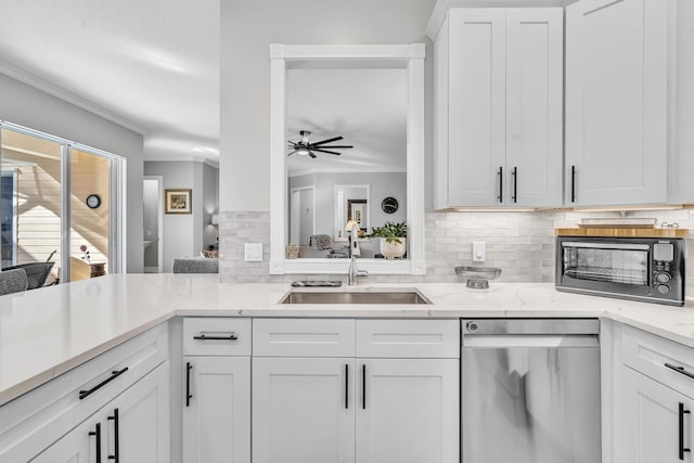 kitchen featuring a ceiling fan, light stone countertops, stainless steel dishwasher, white cabinetry, and a sink