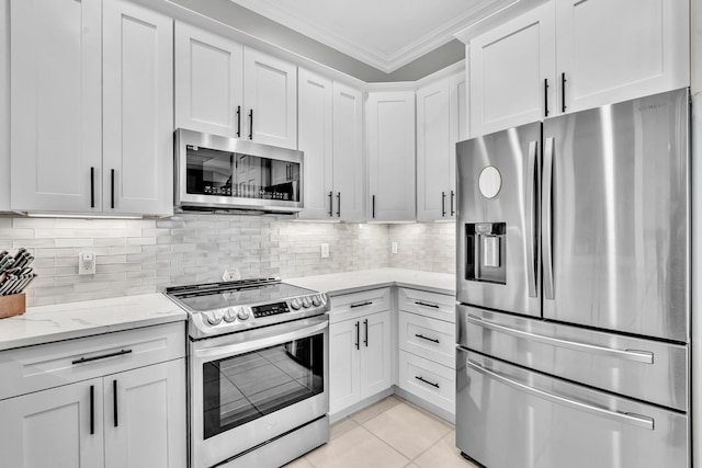 kitchen with stainless steel appliances, white cabinets, crown molding, and light stone countertops