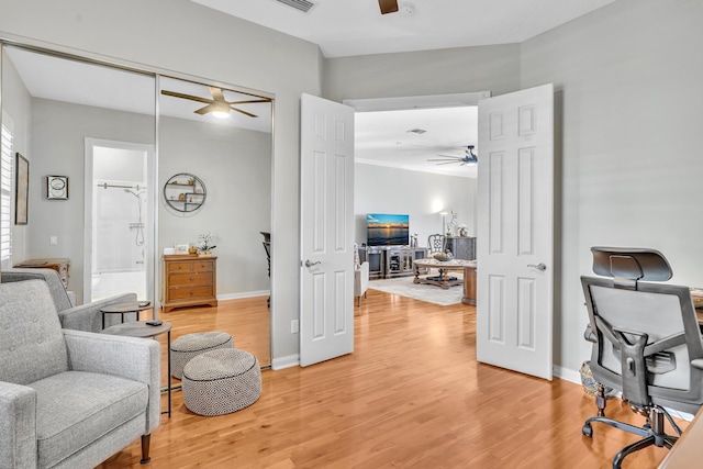 sitting room with baseboards, a ceiling fan, and wood finished floors