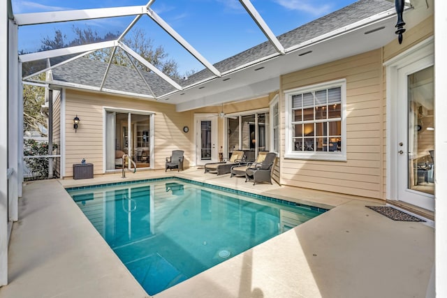 pool with a lanai, outdoor lounge area, and a patio