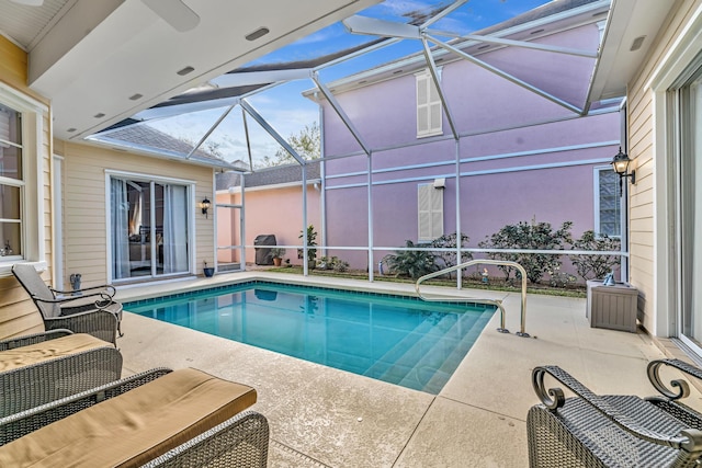 pool with glass enclosure and a patio area