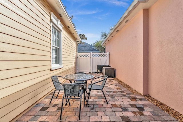 view of patio featuring fence and outdoor dining area