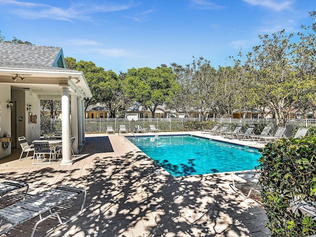 community pool featuring fence and a patio