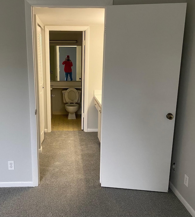 hallway with carpet and baseboards