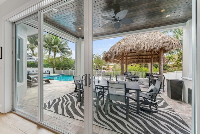 view of patio featuring a fenced backyard, a fenced in pool, outdoor dining space, and a ceiling fan