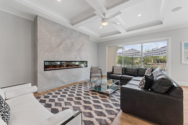 living area featuring wood finished floors, coffered ceiling, a high end fireplace, and beam ceiling