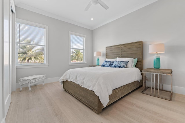 bedroom with ceiling fan, baseboards, light wood finished floors, and ornamental molding