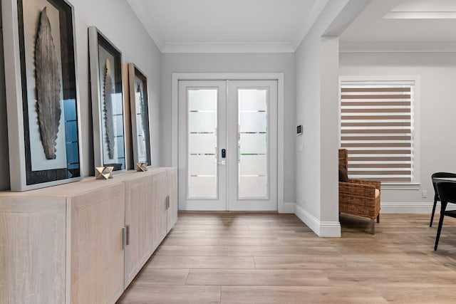 foyer featuring crown molding, french doors, light wood-style floors, and baseboards