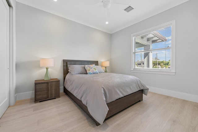 bedroom with ceiling fan, baseboards, visible vents, and light wood-type flooring