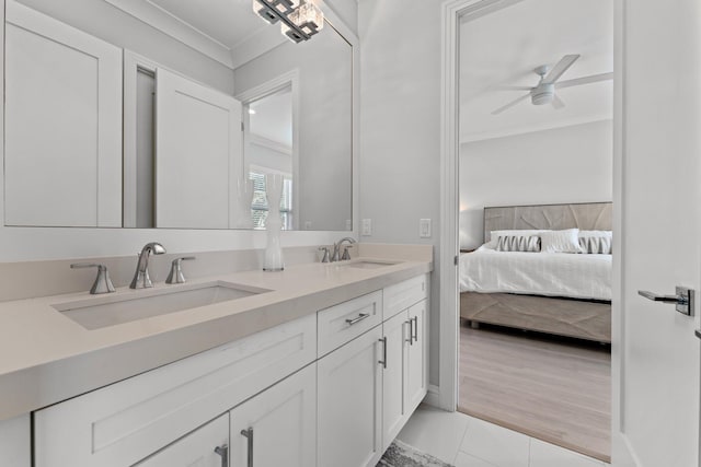 full bathroom with a sink, double vanity, ornamental molding, and ensuite bathroom