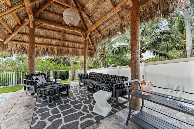 view of patio featuring a gazebo, an outdoor hangout area, and fence